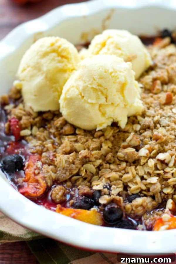 Golden Baked Peaches with a Sweet Pecan-Oat Crumble 10 A vibrant Peach Blueberry Oatmeal Crumble, bursting with fresh fruits and topped with a golden, buttery oat crumble. Served with a generous scoop of vanilla ice cream, making it an irresistible summer dessert.