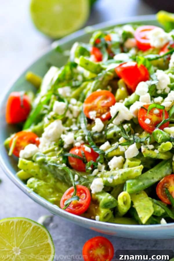 Avocado Green Goddess Green Beans 4 Freshly blanched green beans tossed with cherry tomatoes and feta, waiting for avocado green goddess dressing