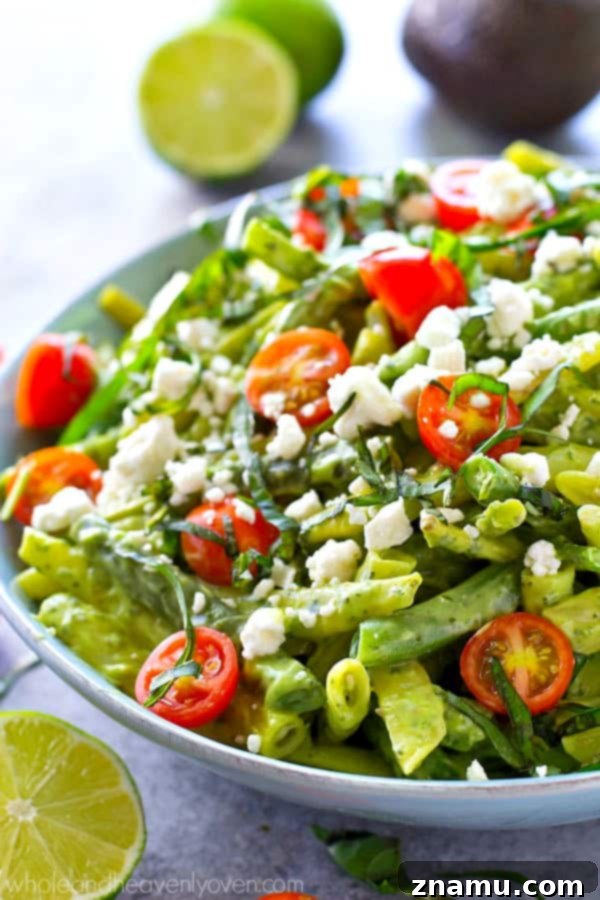 Avocado Green Goddess Green Beans 6 Finished Green Bean Salad in a bowl, showing the mix of beans, tomatoes, feta, and a rich green dressing