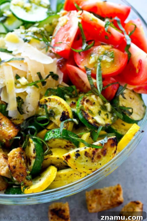 Grilled Summer Panzanella 7 A close-up shot of the fresh ingredients for Grilled Garden-Style Panzanella Salad, featuring juicy heirloom tomatoes, crisp cucumber slices, and vibrant green basil leaves, illustrating the quality of the produce.