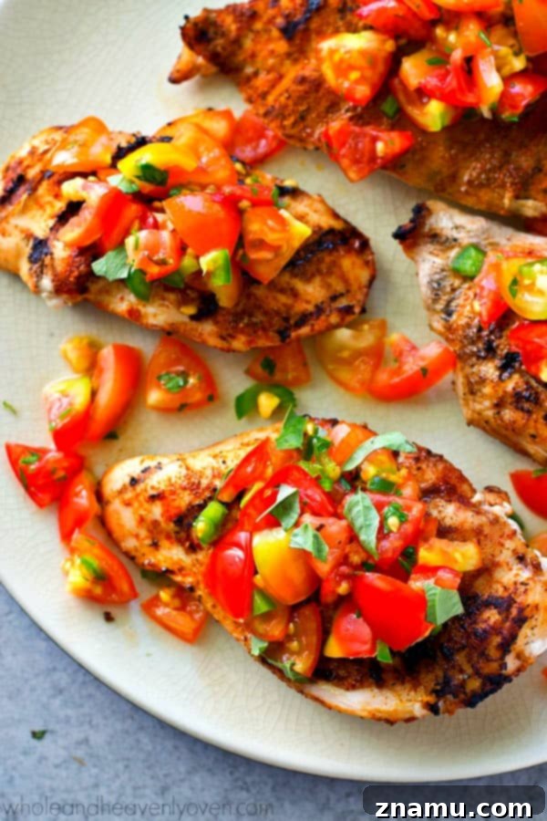 Fiesta Grilled Chicken with Fresh Salsa 2 Perfectly grilled cumin-rubbed chicken breasts topped with fresh tomato salsa, ready in under 20 minutes for a quick summer dinner.