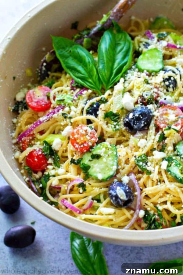 Mediterranean Spaghetti Toss with Zesty Dijon-Parmesan 2 A vibrant bowl of Loaded Greek Spaghetti Pasta Salad with a creamy Dijon Parmesan dressing, ready to be served.