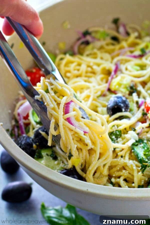 Mediterranean Spaghetti Toss with Zesty Dijon-Parmesan 4 Ingredients for Greek Spaghetti Pasta Salad displayed in a bowl, ready for mixing.
