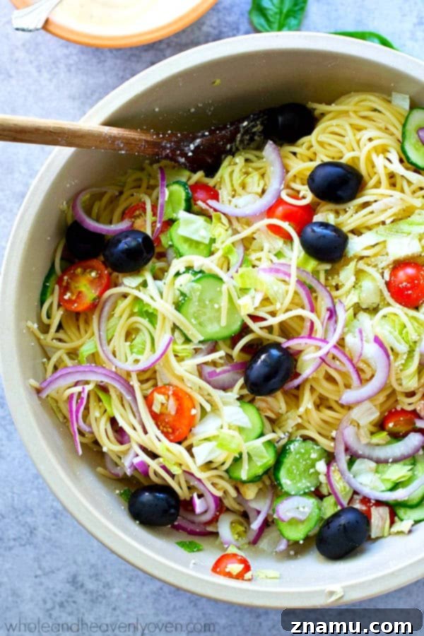 Mediterranean Spaghetti Toss with Zesty Dijon-Parmesan 5 A serving of Greek Spaghetti Pasta Salad with a generous drizzle of the creamy Dijon Parmesan dressing.