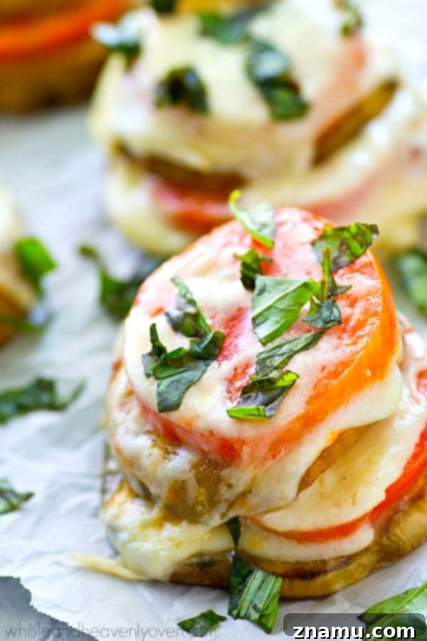Caprese Towers with Heirloom Tomatoes and Eggplant 2 Freshly made Caprese stacks with vibrant heirloom tomatoes, roasted eggplant, creamy mozzarella, and fragrant basil leaves, ready to be enjoyed.