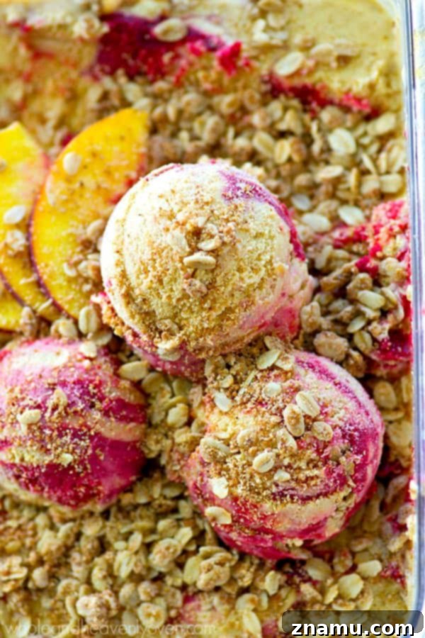 Golden Peach Crumble & Raspberry Ripple Ice Cream 6 Raspberry swirl being gently folded into the peach ice cream base, showing the marbling effect