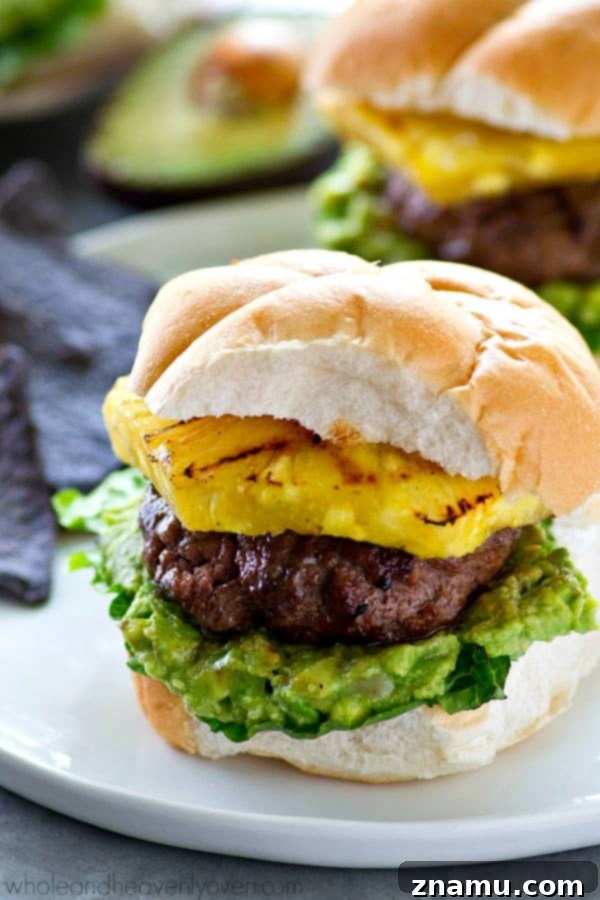 Jerk-Grilled Hamburgers with Avocado and Grilled Pineapple 2 Sweet 'n' spicy jerk-flavored hamburgers topped with smashed avocado and grilled pineapple on a bun