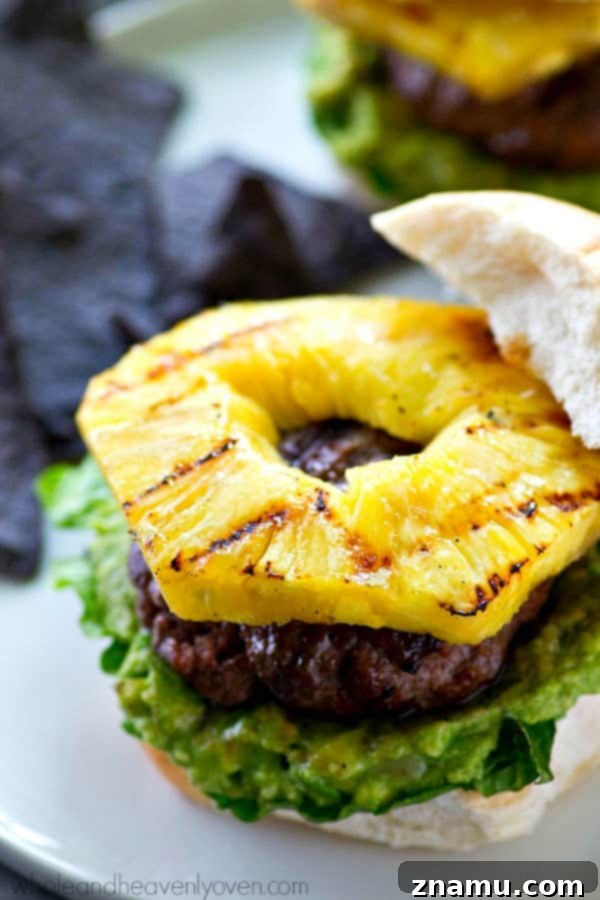 Jerk-Grilled Hamburgers with Avocado and Grilled Pineapple 5 Jerk seasoned beef patties sizzling on a hot grill