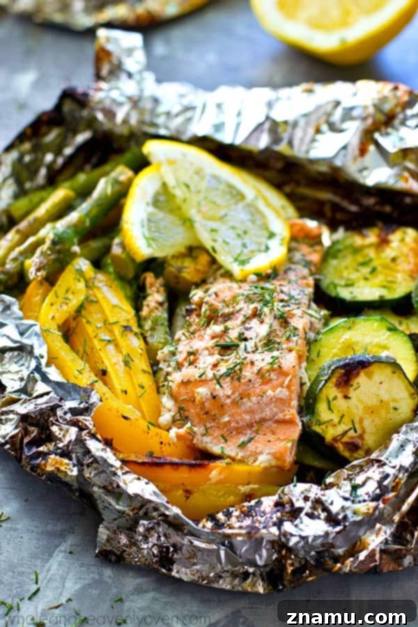A vibrant close-up shot of raw salmon fillets nestled amongst crisp green asparagus spears and bright yellow sweet pepper slices, all prepared inside a foil packet, ready for grilling. The ingredients look fresh and enticing.