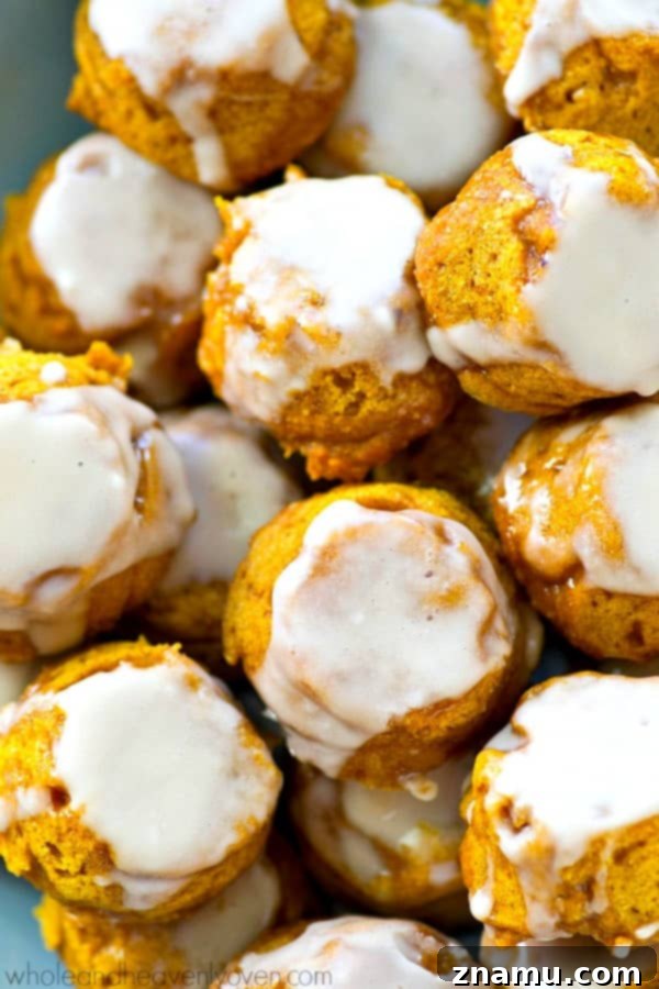 Lighter Pumpkin Spice Glaze Poppers 2 Pillow-soft pumpkin spice donut holes glistening with vanilla glaze, ready for fall enjoyment.