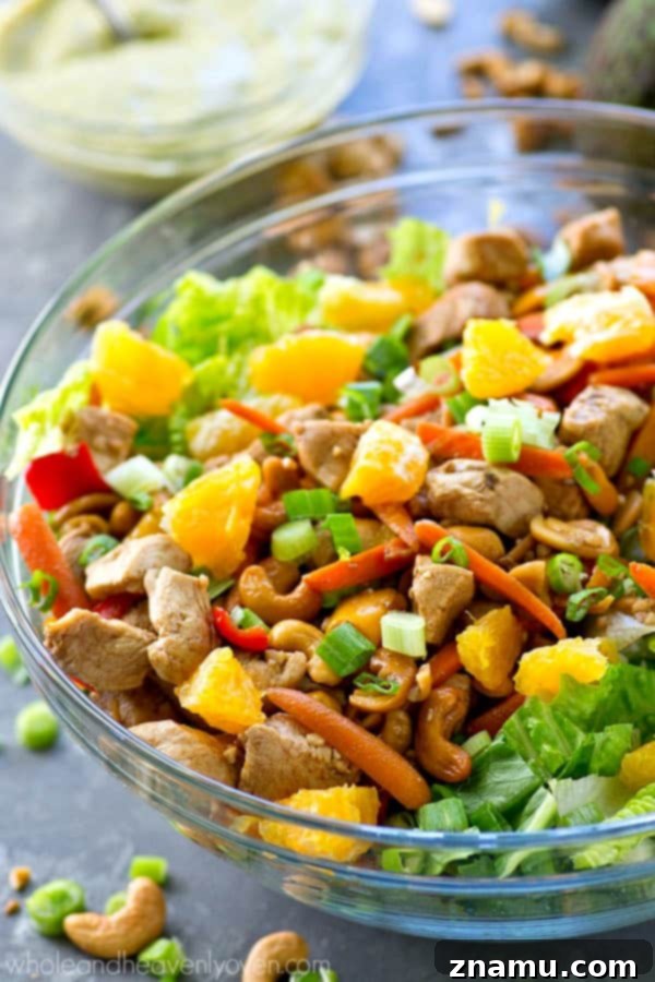 Creamy Chipotle Avocado Cashew Chicken Salad 6 Close-up of the creamy chipotle avocado dressing being drizzled over the cashew chicken salad, showing its rich texture.