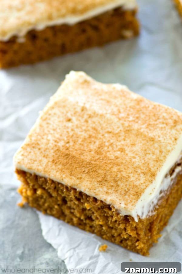 Spiced Applesauce Snack Cake with Cream Cheese Frosting 5 Delicious applesauce cake square with frosting, ready to eat