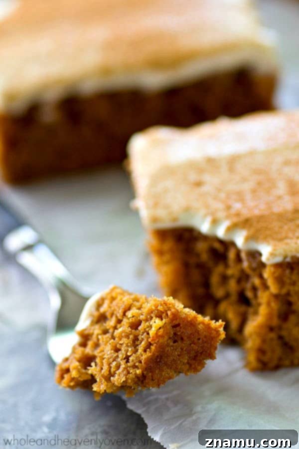 Spiced Applesauce Snack Cake with Cream Cheese Frosting 6 Large slab of applesauce snack cake on a white cutting board, partially sliced