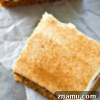 Spiced Applesauce Snack Cake with Cream Cheese Frosting 9 This soft applesauce snack cake gets mixed up in minutes and it bakes up perfectly every time! Smother this cake in tangy cream cheese frosting for one winner fall snack or dessert.