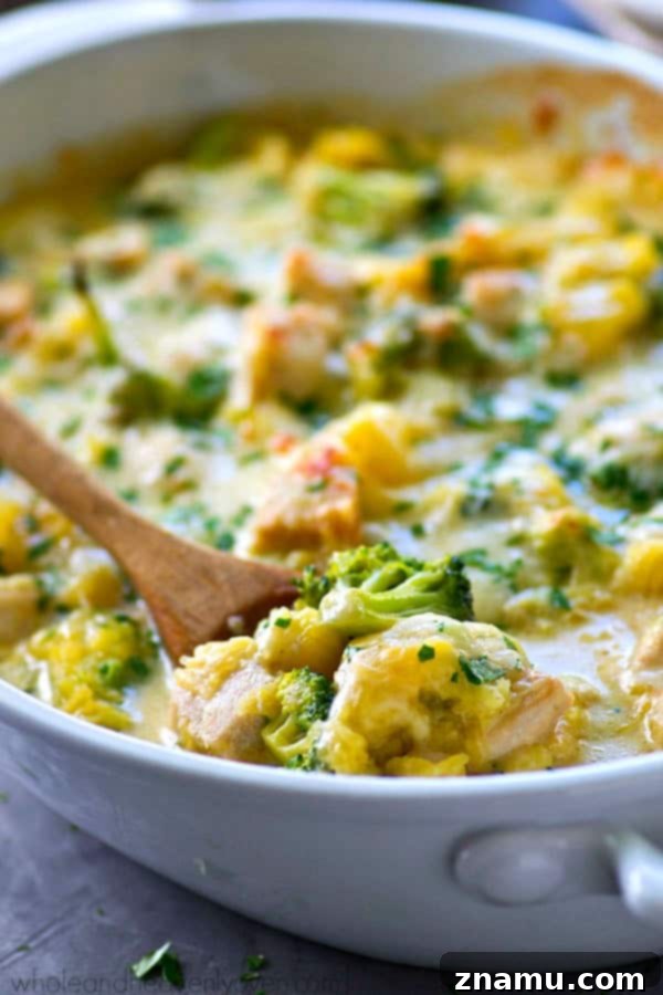 Golden Three-Cheese Chicken and Broccoli Spaghetti Squash Bake 5 A close-up shot of the three-cheese topping stretching beautifully as a spoonful is lifted from the casserole.