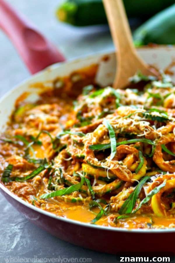 Creamy Sun-Dried Tomato Zucchini Alfredo Noodles 5 Freshly grated Parmesan cheese and basil on Sun-Dried Tomato Alfredo Zucchini Noodles