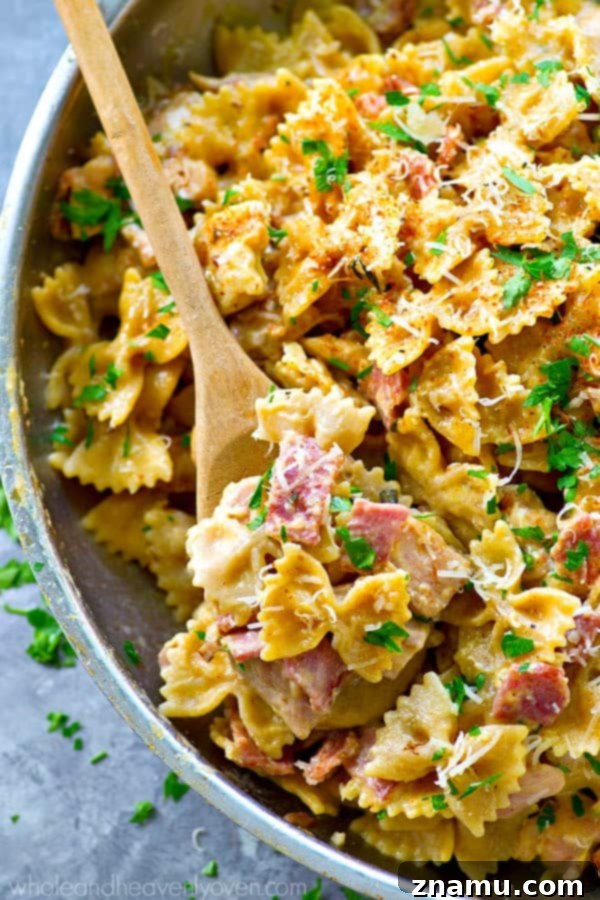 Cajun Chicken & Bacon Alfredo Pasta 3 Sizzling chicken and bacon in a skillet, the foundation of a flavorful one-pot Cajun pasta.