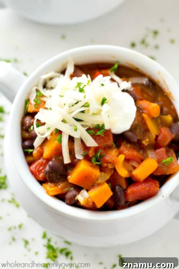 Smoky Hearty Slow Cooker Chipotle Chicken Chili 10 A vibrant bowl of 30-minute vegetarian chili, garnished with avocado and cilantro, suitable for a healthy game-day dinner.