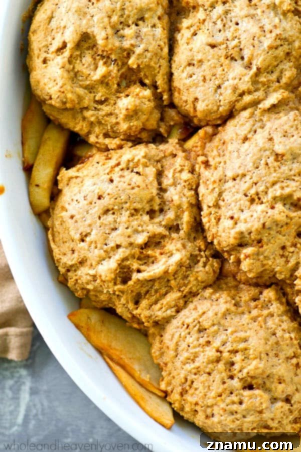 Brown Butter Biscuit Apple Cobbler 4 Raw apple cobbler filling in a pan, topped with unbaked browned butter biscuit dough.