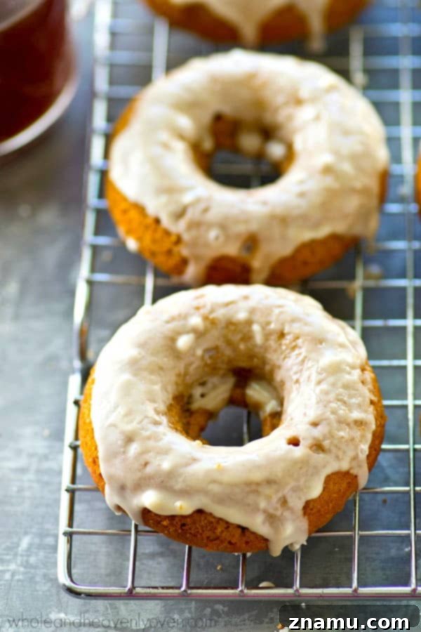 Espresso Glazed Pumpkin Spice Latte Donuts 7 Freshly glazed pumpkin donuts on a cooling rack