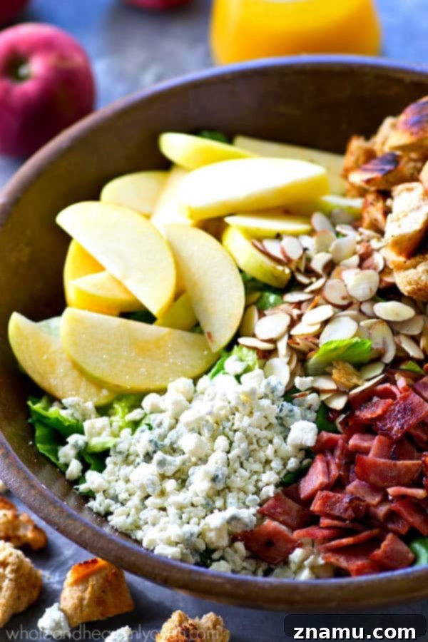 Vibrant Apple Almond Blue Cheese Salad with Zesty Cider Dressing 3 Close-up of a refreshing fall apple salad, showcasing crisp apples, bacon, and blue cheese