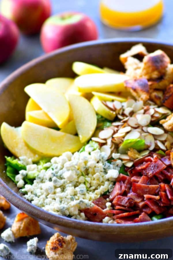 Vibrant Apple Almond Blue Cheese Salad with Zesty Cider Dressing 4 A bowl of fall-style apple salad with an apple cider dressing, ready to be enjoyed
