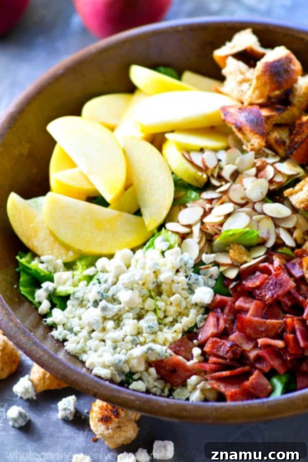 Vibrant Apple Almond Blue Cheese Salad with Zesty Cider Dressing 8 A close-up view of the fall-style apple salad with extra dressing and blue cheese