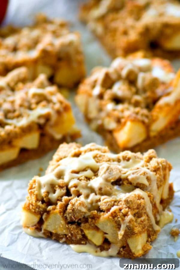 Apple Streusel Bars with Vanilla Glaze 4 Freshly baked Glazed Apple Pie Crumb Bars cooling on a wire rack
