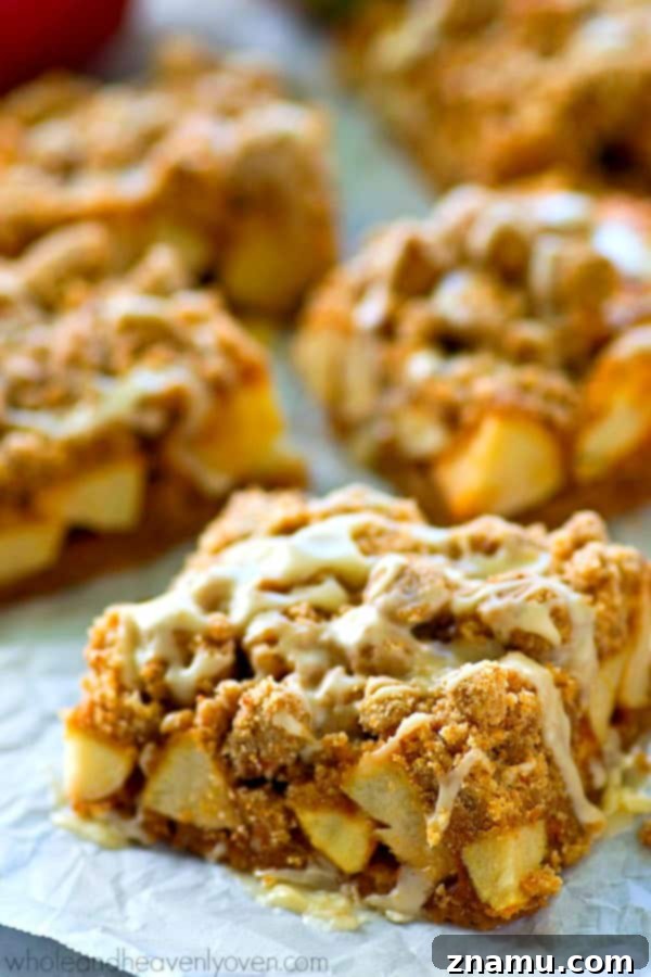 Apple Streusel Bars with Vanilla Glaze 6 Close-up of the delicious layers of Glazed Apple Pie Crumb Bars, showcasing the crisp crust, tender filling, crumbly topping, and shiny glaze
