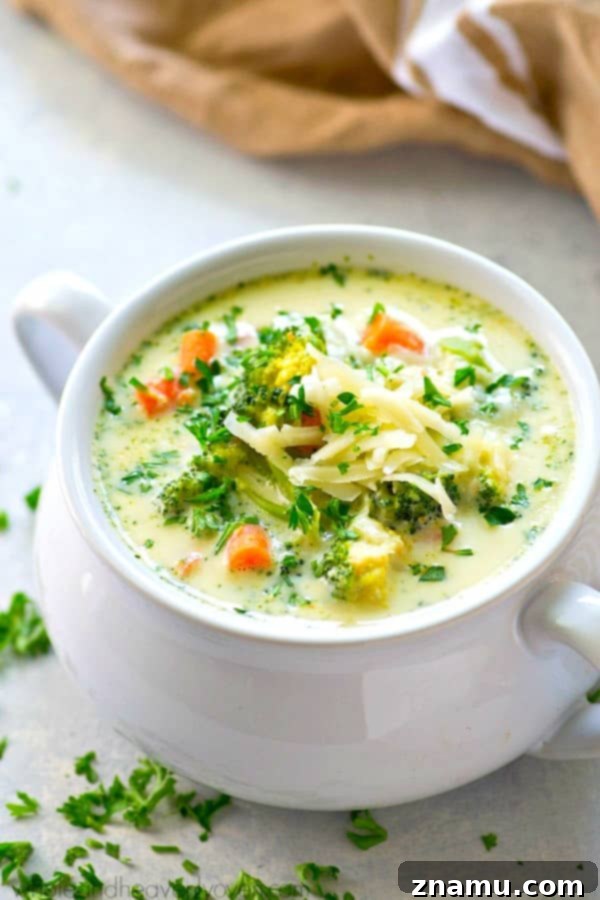 Wholesome Slow Cooker Broccoli Cheddar Soup 7 A delicious bowl of Lighter Crockpot Broccoli Cheese Soup, garnished with fresh parsley and extra shredded cheddar.