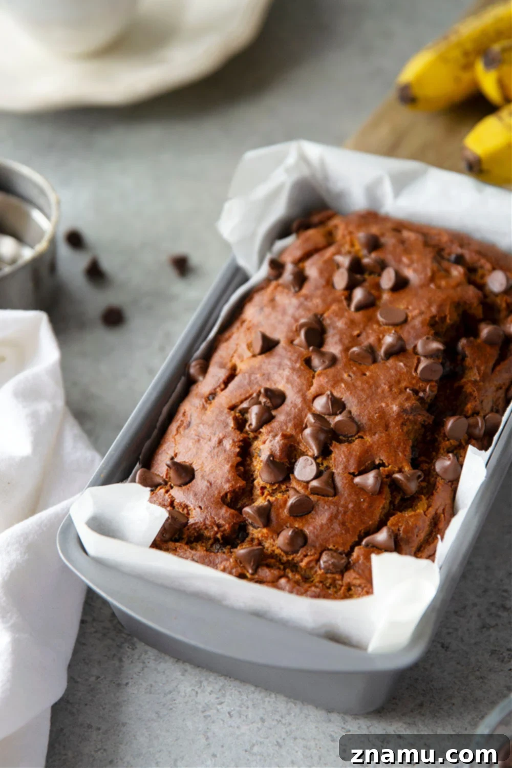 Spiced Banana Chocolate Chip Pumpkin Loaf 5 Unbaked Banana Chocolate Chip Pumpkin Bread batter in a loaf pan, ready for baking.