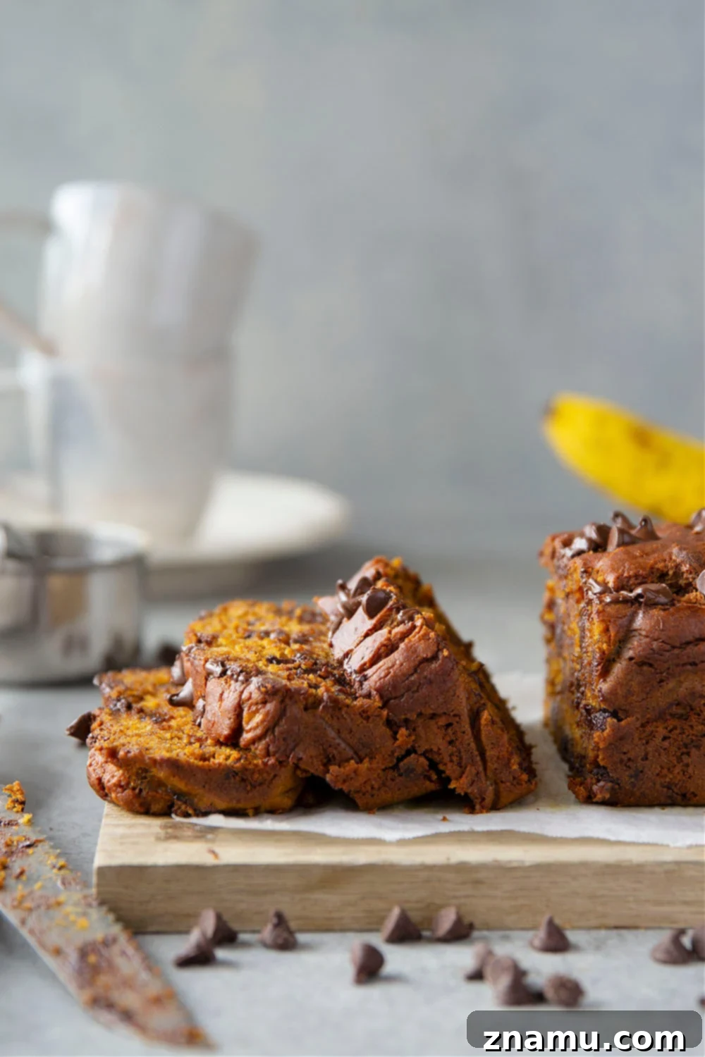 Spiced Banana Chocolate Chip Pumpkin Loaf 6 Close-up of freshly sliced Banana Chocolate Chip Pumpkin Bread on a cooling rack.