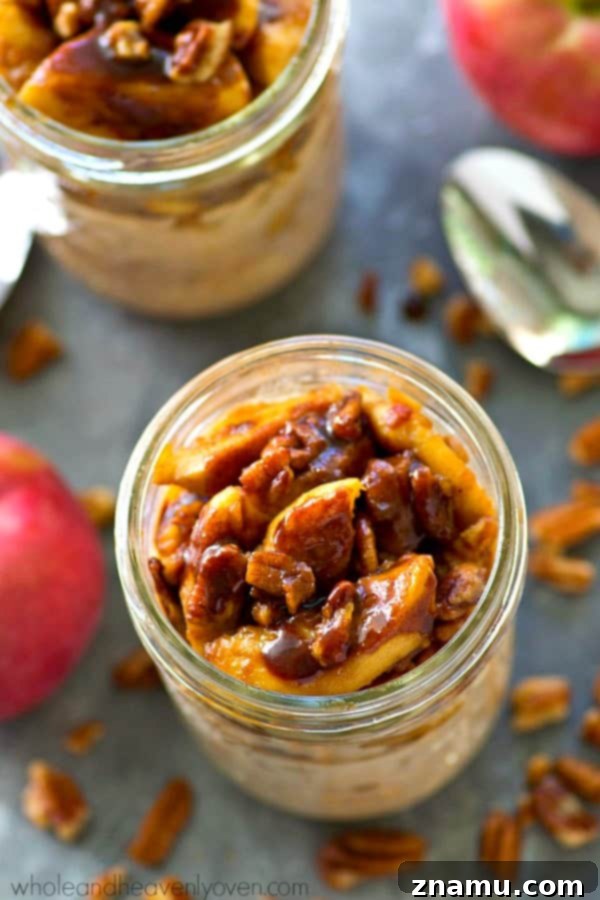 Individual servings of Caramelized Apple Cinnamon Roll Overnight Oats in bowls, topped with a generous portion of apples.