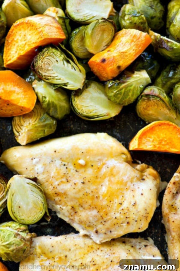 Juicy maple chicken, and tender sweet potatoes and brussels sprouts are are all roasted to perfection in ONE pan in less than an hour for an easy weeknight dinner with ZERO work involved!
