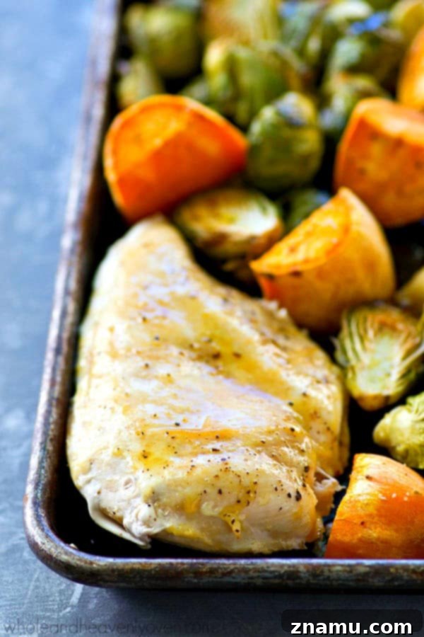 Juicy maple chicken, and tender sweet potatoes and brussels sprouts are are all roasted to perfection in ONE pan in less than an hour for an easy weeknight dinner with ZERO work involved!