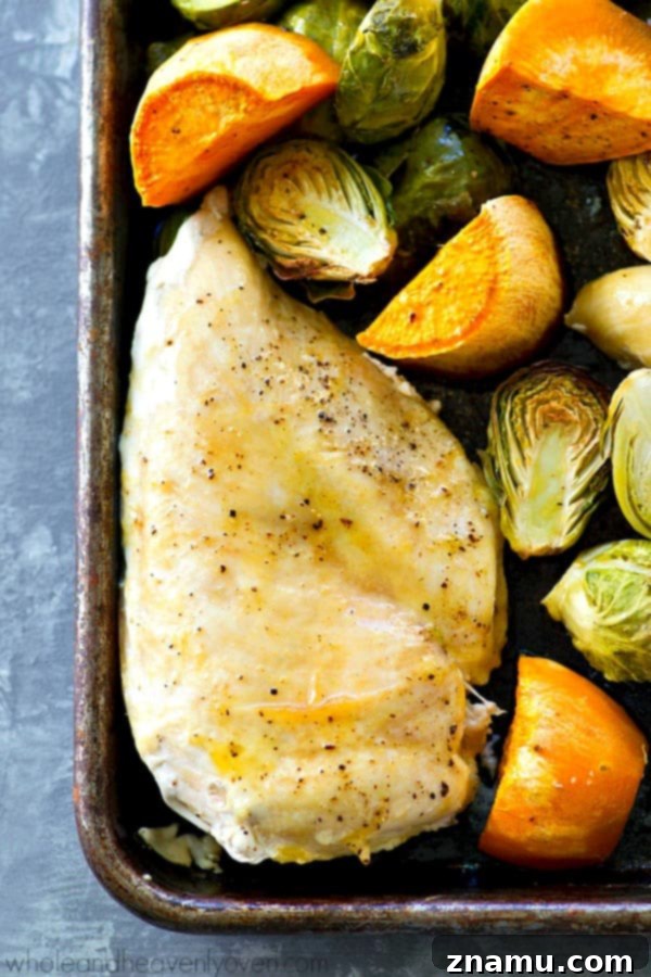 Juicy maple chicken, and tender sweet potatoes and brussels sprouts are are all roasted to perfection in ONE pan in less than an hour for an easy weeknight dinner with ZERO work involved!