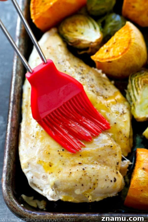 Juicy maple chicken, and tender sweet potatoes and brussels sprouts are are all roasted to perfection in ONE pan in less than an hour for an easy weeknight dinner with ZERO work involved!