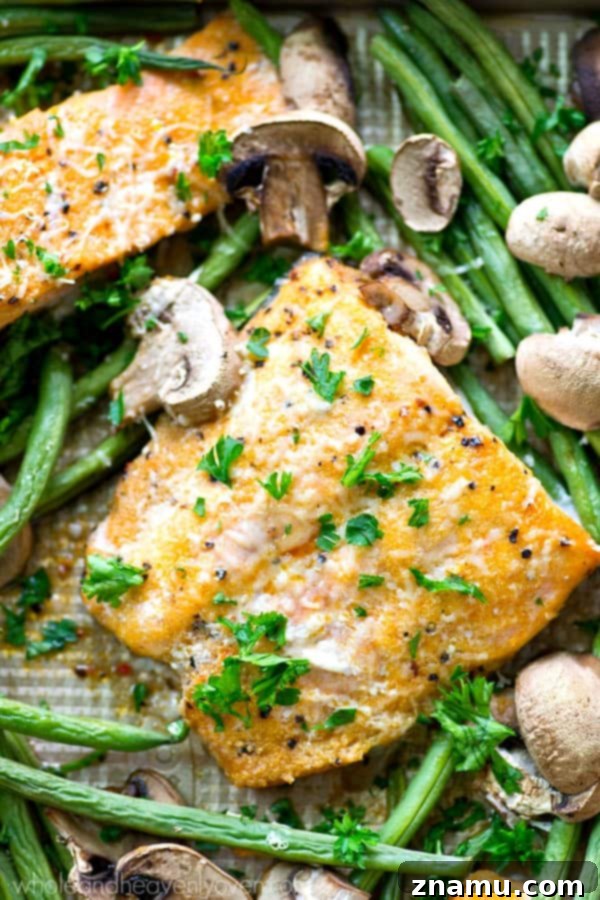 One Pan Lemon Garlic Parmesan Salmon with Green Beans and Mushrooms 2 Roasted in a flavorful lemon garlic Parmesan sauce and lots of little mushrooms and green beans, this baked salmon is a breeze to throw together for a weeknight dinner and is packed with SO many amazing flavors!