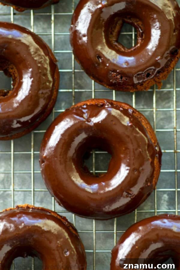 Glazed Mocha Banana Baked Delights 5 Freshly baked mocha banana donuts cooling on a wire rack