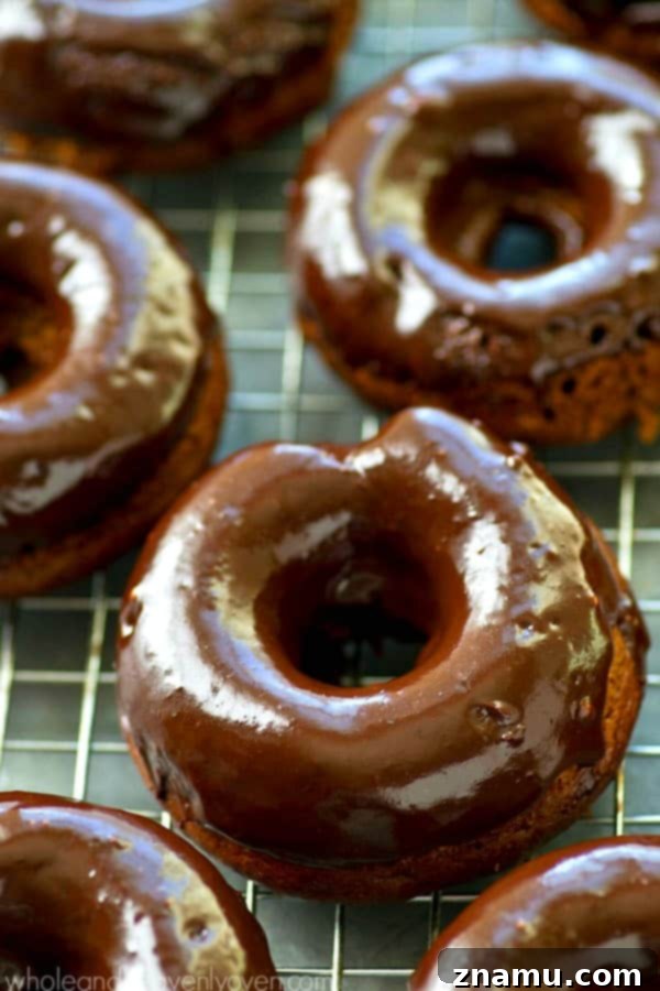 Glazed Mocha Banana Baked Delights 7 Assortment of freshly glazed mocha banana baked donuts on a cooling rack