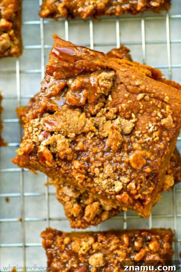 Spiced Pumpkin Caramel Crumble Bars 7 Caramel glaze being drizzled over pumpkin pie crumb bars