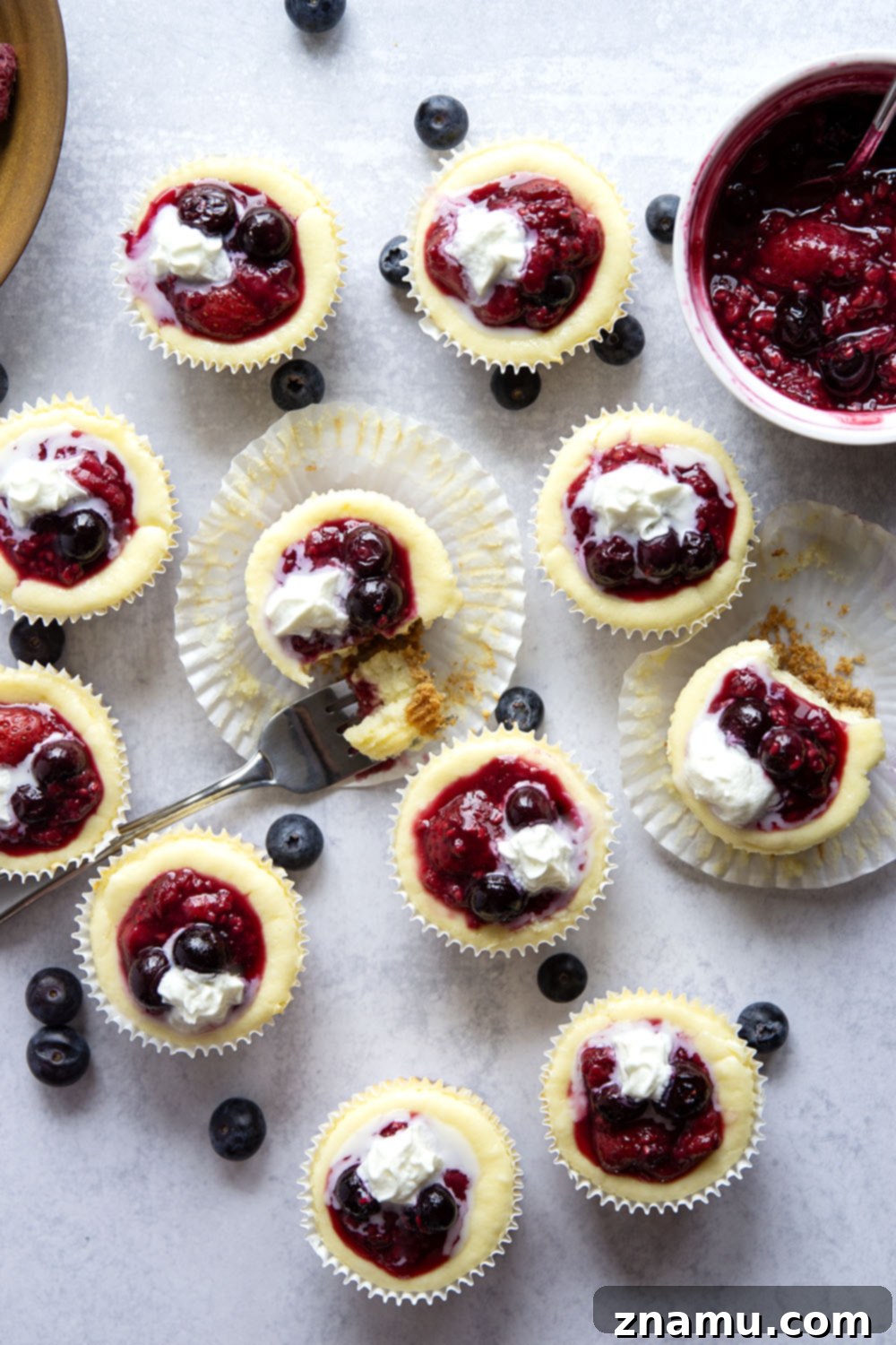 Berry Cheesecake Bites 6 A tray of beautifully topped Berry Mini Cheesecakes with whipped cream, ready to be served
