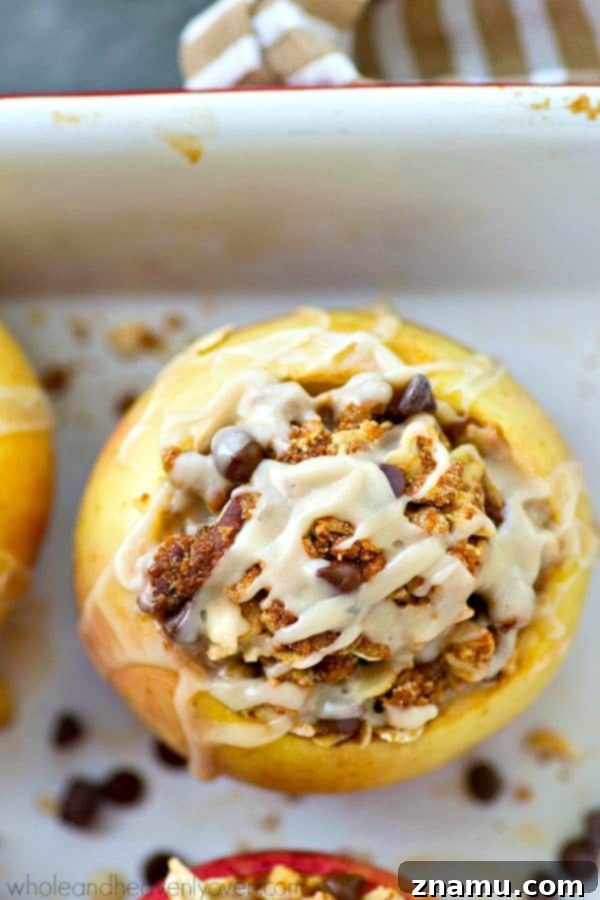 Chocolate Chip Iced Oatmeal Baked Apples 4 A row of freshly baked apples, stuffed with cookie dough and ready for a smooth icing glaze.