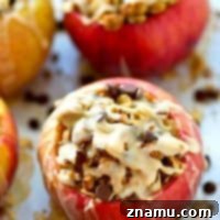 Baked apples are stuffed with a decadent oatmeal chocolate chip cookie filling and drizzled with tons of icing for one killer fall dessert you won't be able to resist!