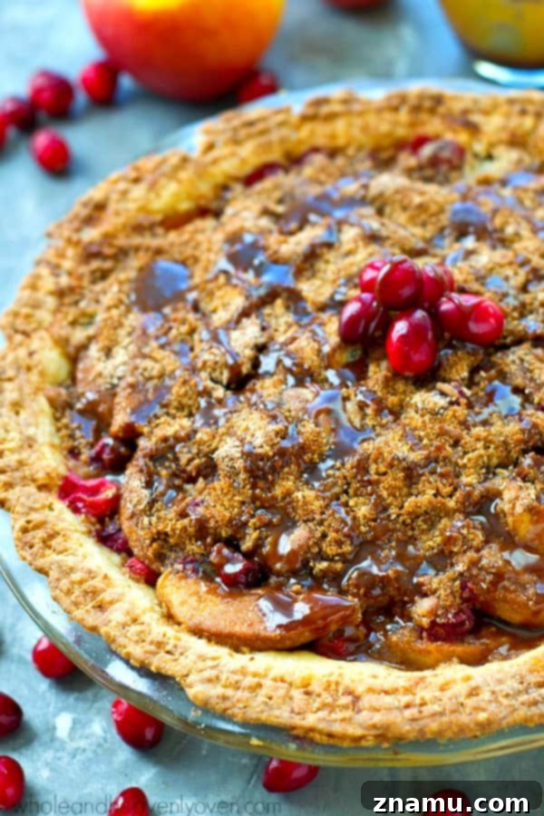 Golden Caramel Apple Cranberry Crumble 4 Freshly baked Cranberry Caramel Apple Crumb Pie cooling on a rack, showcasing its beautiful texture