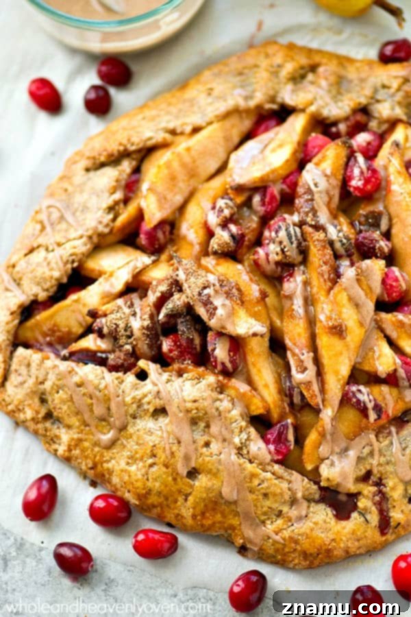 Beautifully rustic pear cranberry galette, perfectly baked and ready for chai spice glaze.