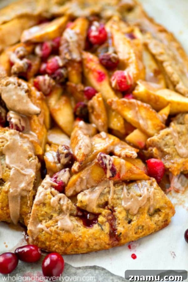 Freshly baked pear cranberry galette, golden brown and bubbling with fruit.