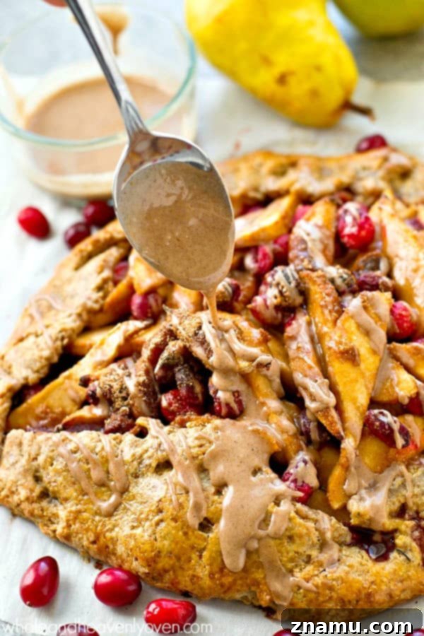 A slice of pear cranberry galette topped with luscious chai glaze, ready to be enjoyed.