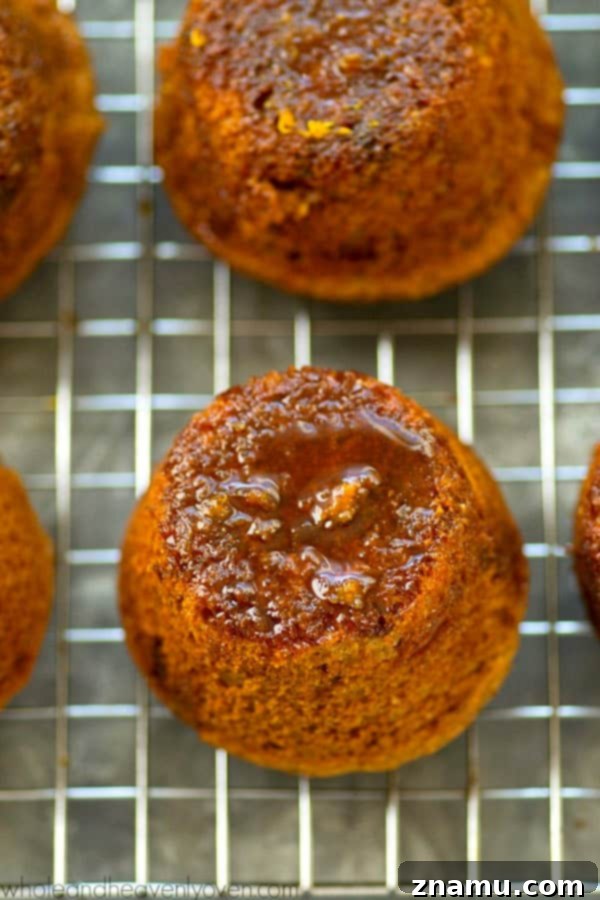 Zingy Sticky Orange Gingerbread Muffins 2 Freshly baked gingerbread muffins with sticky orange glaze, perfect for holiday mornings.