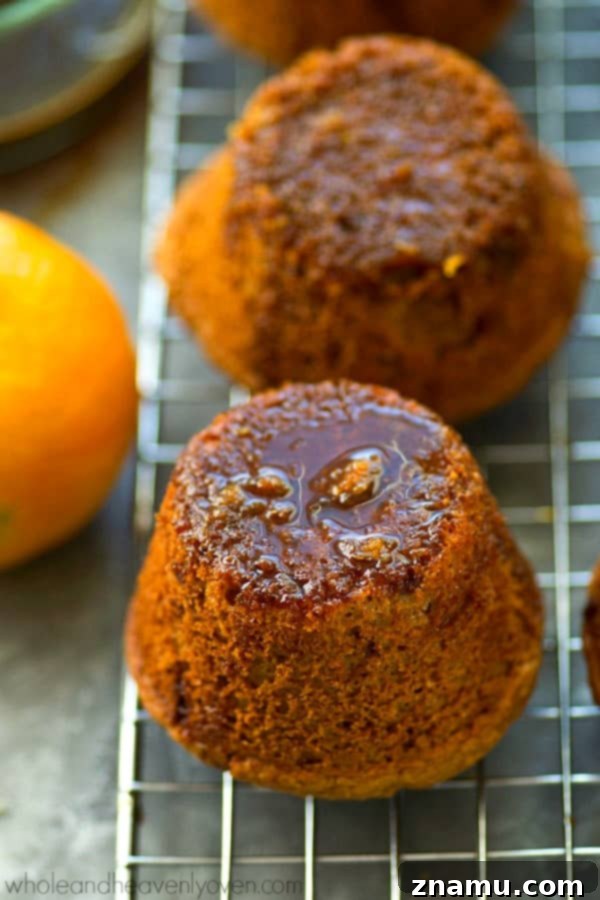 Zingy Sticky Orange Gingerbread Muffins 5 Hand brushing warm orange glaze onto a gingerbread muffin, ensuring maximum moisture.